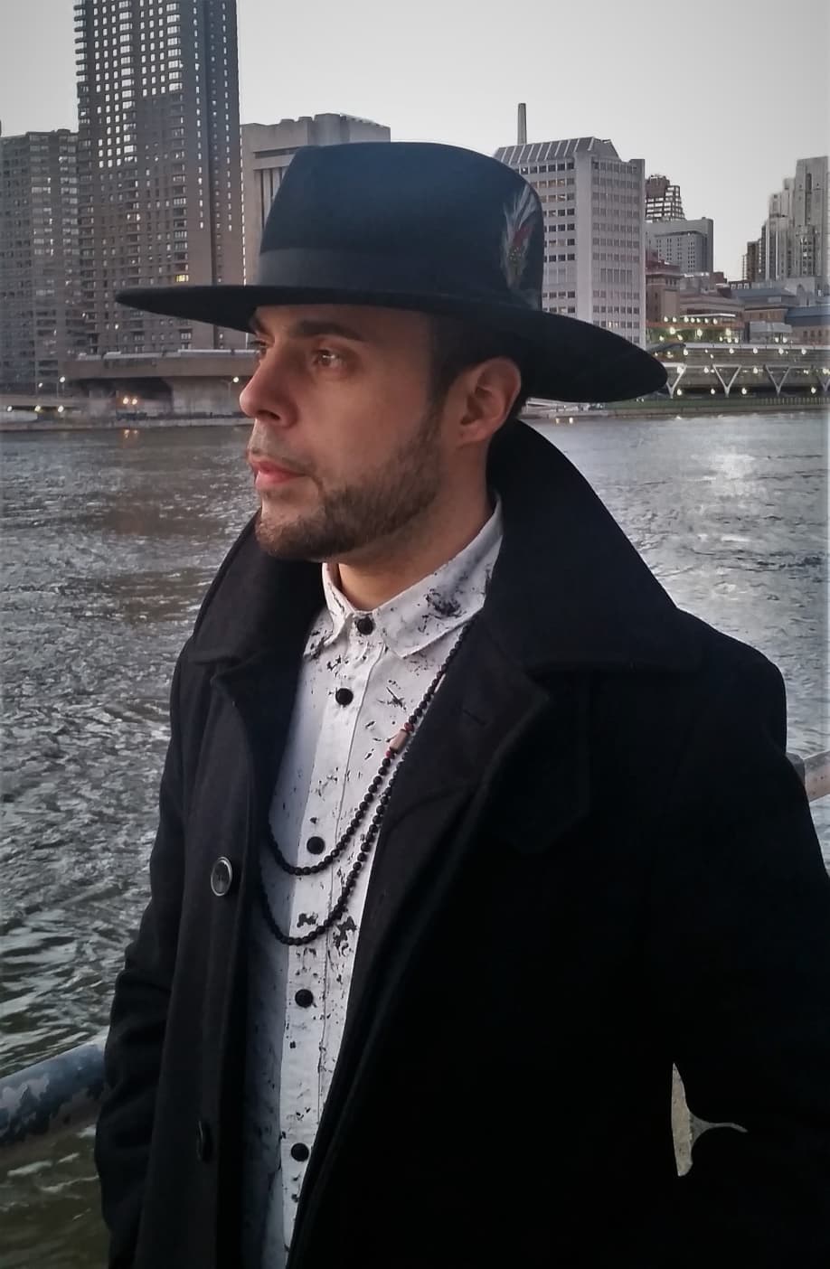 DJ LexNY by the East River, Manhattan skyline behind