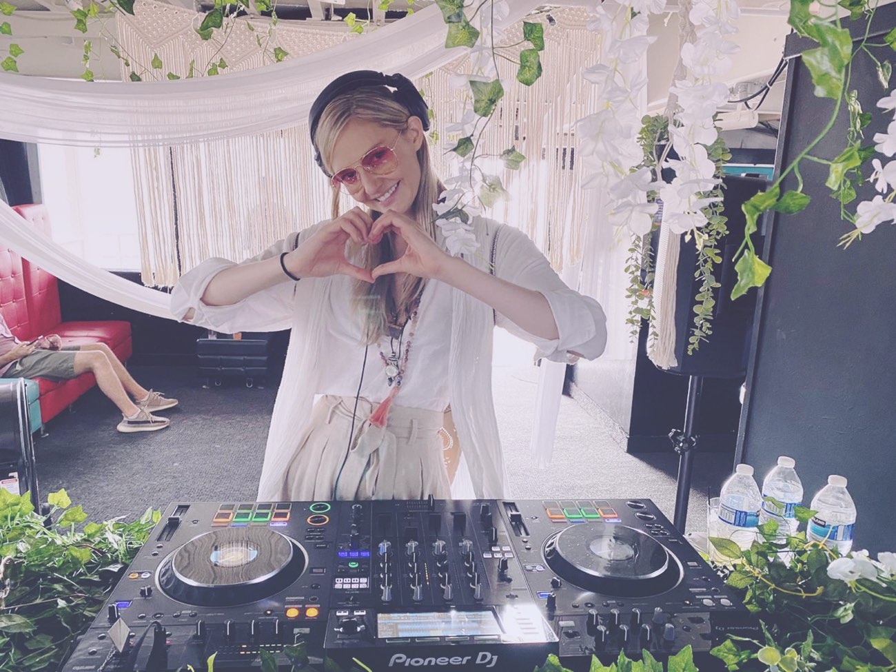 Olga Cerpita making a heart at a daytime garden set