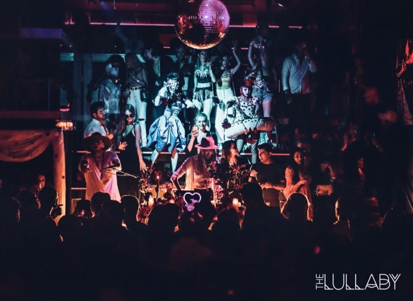 Olga Cerpita DJing at The Lullaby beneath the disco ball